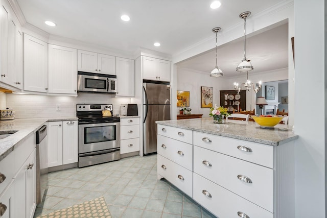 239 Sea Rd Unit 32, Kennebunk, ME 04043 - kitchen featuring appliances with stainless steel finishes, crown molding, white cabinets, and recessed lighting
