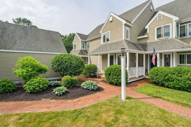 239 Sea Rd Unit 32, Kennebunk, ME 04043 - view of front of property with a porch, a shingled roof, and a front lawn
