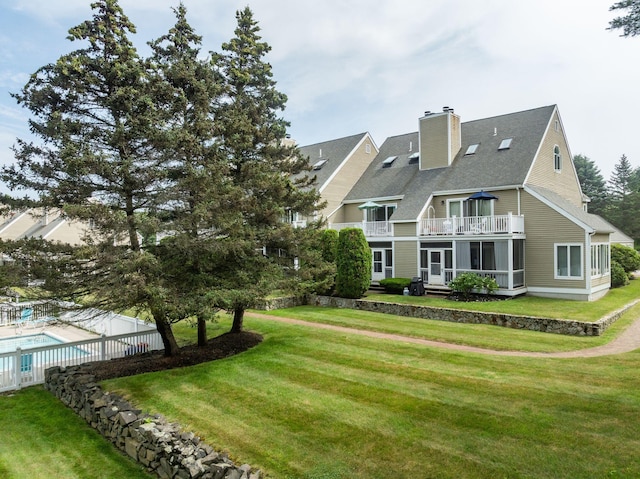239 Sea Rd Unit 32, Kennebunk, ME 04043 - back of house featuring a balcony, a chimney, and a shingled roof