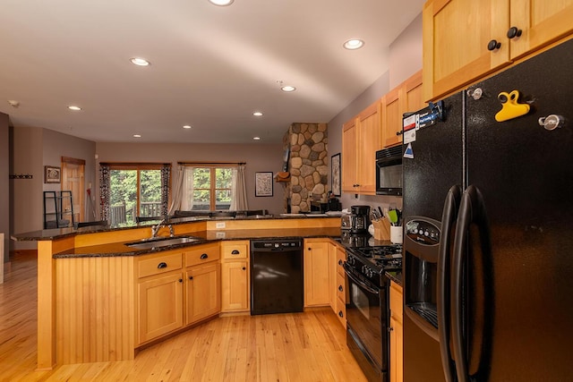 7022 Hardwood Ridge Rd Unit 7022, Carrabassett Valley, ME 04947 - kitchen with black appliances, a peninsula, light wood-style floors, recessed lighting, and dark stone counters