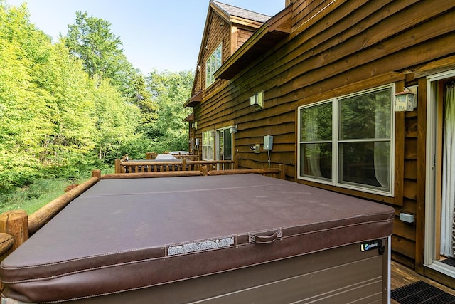 7022 Hardwood Ridge Rd Unit 7022, Carrabassett Valley, ME 04947 - view of patio featuring a hot tub and a wooden deck