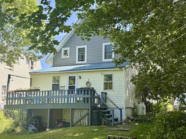 21 Wilson St, Eastport, ME 04631 - back of property featuring a wooden deck, a metal roof, and a lawn