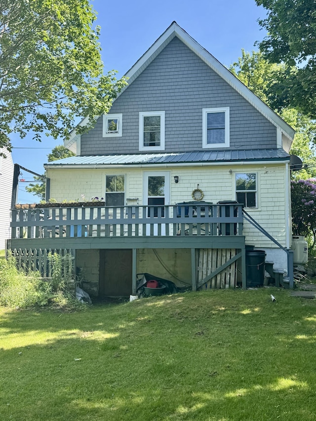21 Wilson St, Eastport, ME 04631 - back of property with a wooden deck, a yard, and a metal roof