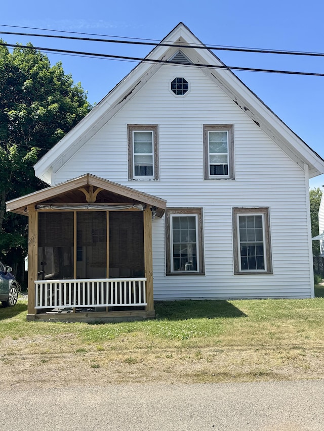 21 Wilson St, Eastport, ME 04631 - view of property exterior with a sunroom and a lawn