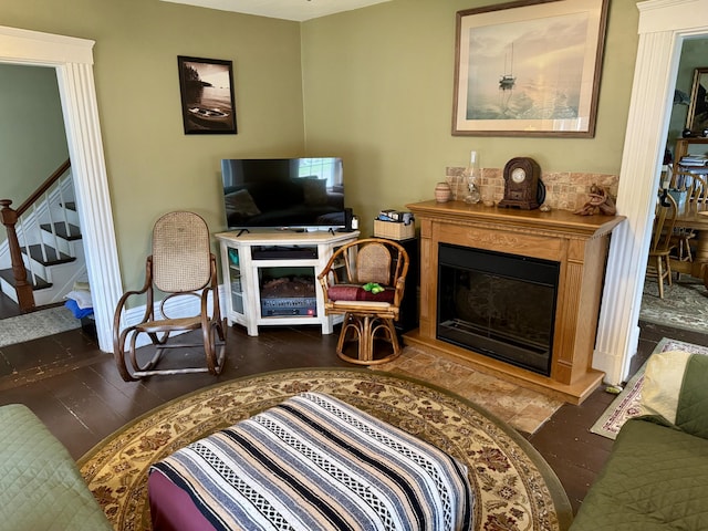 21 Wilson St, Eastport, ME 04631 - living room featuring stairway, a glass covered fireplace, and wood finished floors