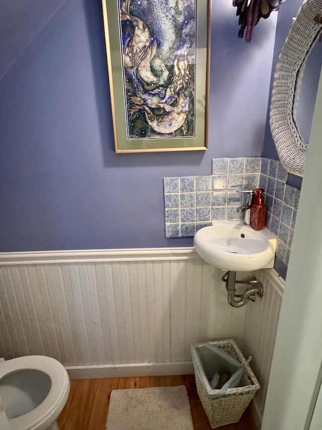 21 Wilson St, Eastport, ME 04631 - half bathroom with wainscoting and wood finished floors