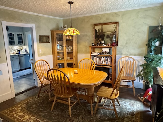 21 Wilson St, Eastport, ME 04631 - dining area with wainscoting, dark wood-style floors, and crown molding