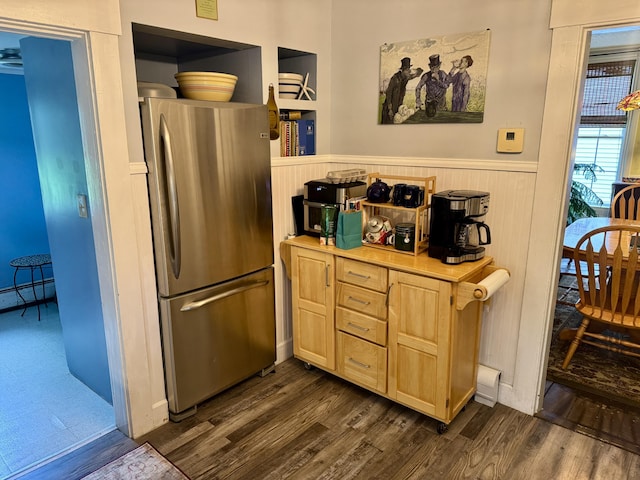 21 Wilson St, Eastport, ME 04631 - kitchen with freestanding refrigerator, a wainscoted wall, dark wood-type flooring, light brown cabinetry, and light countertops