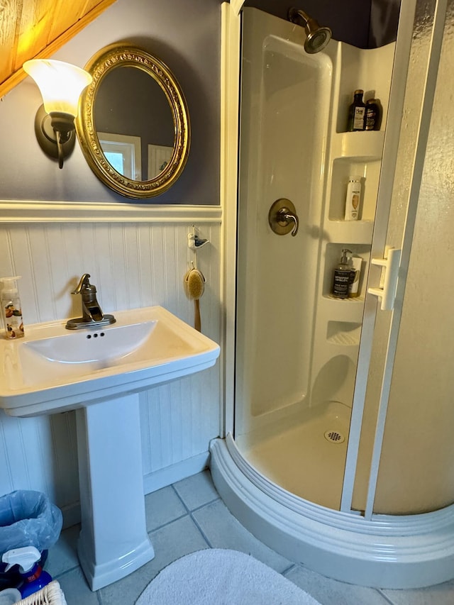 21 Wilson St, Eastport, ME 04631 - full bathroom with a stall shower, a wainscoted wall, and tile patterned flooring