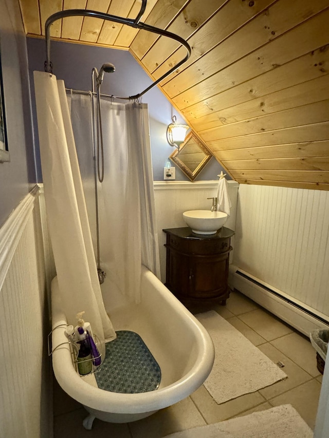 21 Wilson St, Eastport, ME 04631 - full bathroom with baseboard heating, wooden ceiling, lofted ceiling, wainscoting, and tile patterned floors