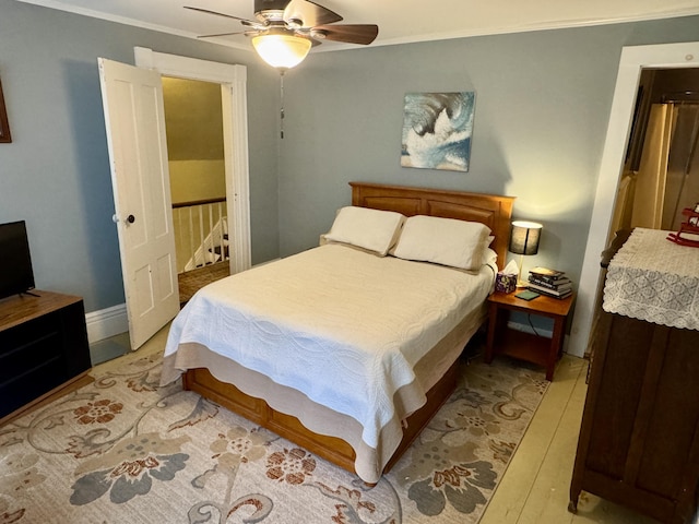 21 Wilson St, Eastport, ME 04631 - bedroom with light wood finished floors, ornamental molding, and ceiling fan
