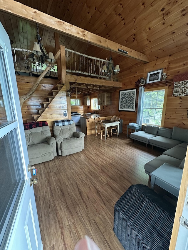322 Lamb Rd, Roxbury, ME 04275 - living room with wood ceiling, wooden walls, wood finished floors, and stairs