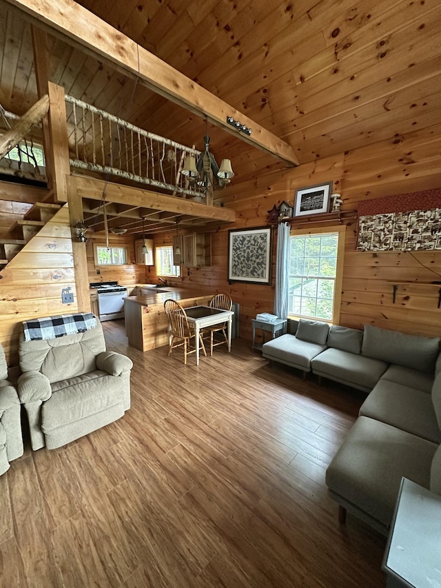 322 Lamb Rd, Roxbury, ME 04275 - living room featuring wood walls, wood finished floors, wood ceiling, stairway, and high vaulted ceiling