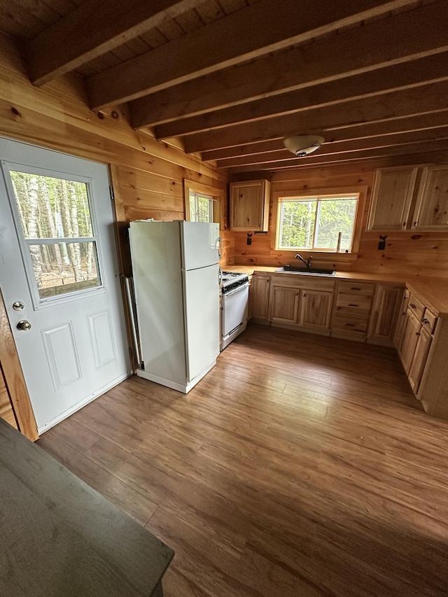 322 Lamb Rd, Roxbury, ME 04275 - kitchen with white appliances, wooden walls, wood finished floors, beam ceiling, and light countertops
