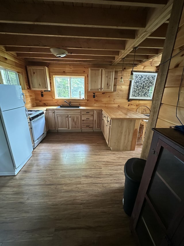322 Lamb Rd, Roxbury, ME 04275 - kitchen featuring white appliances, light brown cabinetry, wooden walls, dark wood finished floors, and beam ceiling
