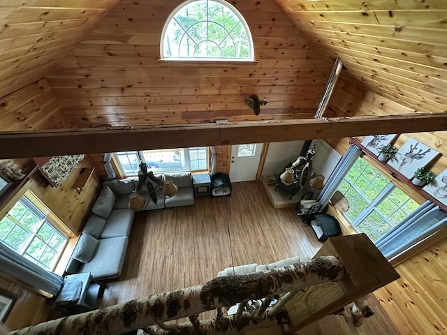 322 Lamb Rd, Roxbury, ME 04275 - living room with high vaulted ceiling, hardwood / wood-style floors, and wooden walls