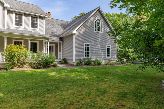 34 Perk Orock Landing Rd, Orono, ME 04473 - back of property with a chimney, covered porch, and a yard