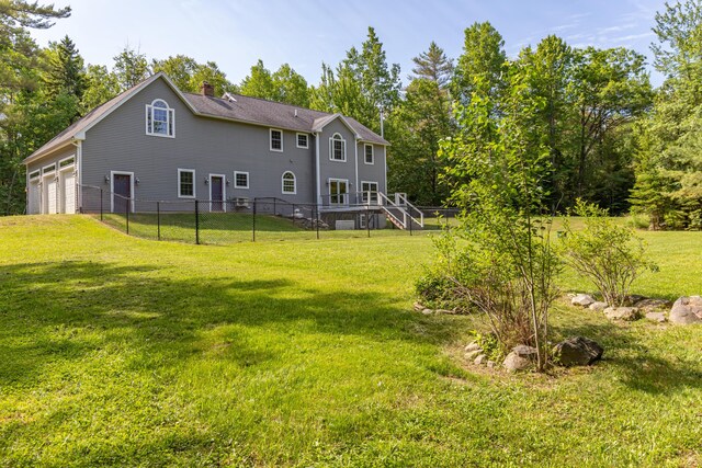 34 Perk Orock Landing Rd, Orono, ME 04473 - back of property with a chimney, an attached garage, and stairs