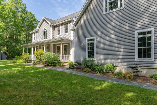 34 Perk Orock Landing Rd, Orono, ME 04473 - view of home's exterior with a lawn and covered porch
