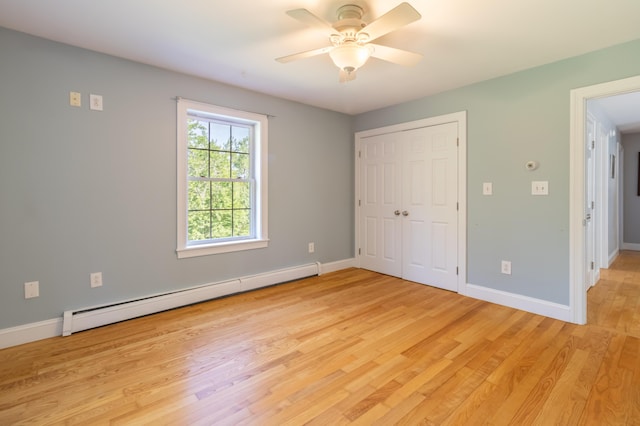 34 Perk Orock Landing Rd, Orono, ME 04473 - unfurnished bedroom with a baseboard heating unit, light wood-type flooring, a closet, and a ceiling fan