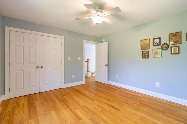 34 Perk Orock Landing Rd, Orono, ME 04473 - unfurnished bedroom with light wood-type flooring, a closet, and ceiling fan