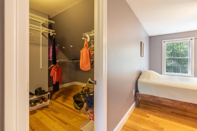 34 Perk Orock Landing Rd, Orono, ME 04473 - bedroom featuring lofted ceiling, wood finished floors, and a closet