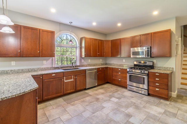 34 Perk Orock Landing Rd, Orono, ME 04473 - kitchen with appliances with stainless steel finishes, hanging light fixtures, brown cabinetry, light stone counters, and recessed lighting