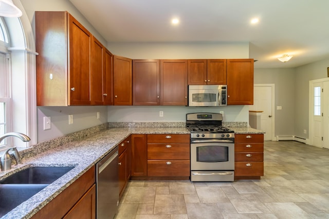 34 Perk Orock Landing Rd, Orono, ME 04473 - kitchen with appliances with stainless steel finishes, light stone counters, a baseboard heating unit, and stone finish flooring