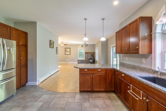 34 Perk Orock Landing Rd, Orono, ME 04473 - kitchen featuring freestanding refrigerator, ceiling fan, a peninsula, and light stone countertops