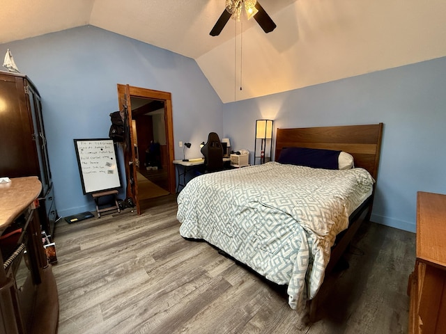 1897 Pequawket Trl, Hiram, ME 04041 - bedroom with vaulted ceiling, wood finished floors, an office area, and a ceiling fan