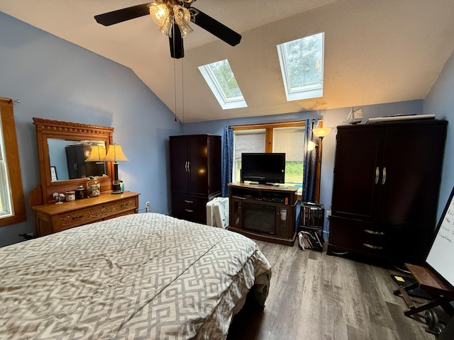 1897 Pequawket Trl, Hiram, ME 04041 - bedroom with vaulted ceiling, wood finished floors, a skylight, and ceiling fan