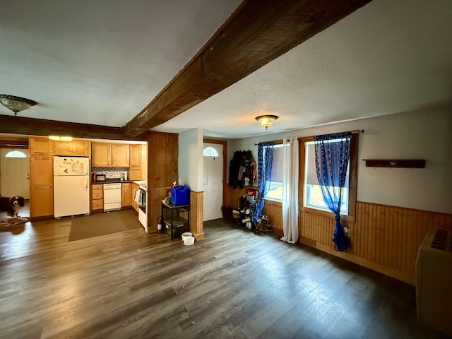 1897 Pequawket Trl, Hiram, ME 04041 - living room featuring dark wood-type flooring, beamed ceiling, wooden walls, a wainscoted wall, and a textured ceiling