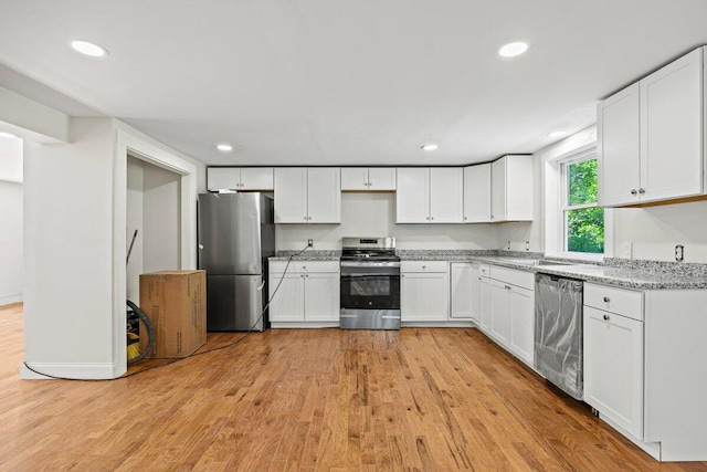 27 Bradford Rd, Wiscasset, ME 04578 - kitchen with appliances with stainless steel finishes, light wood-style flooring, white cabinets, recessed lighting, and light stone countertops