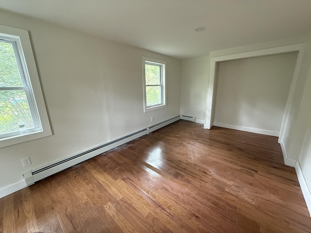 27 Bradford Rd, Wiscasset, ME 04578 - unfurnished room featuring baseboard heating and wood finished floors