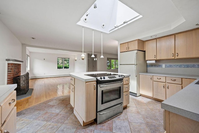 13 Community House Rd, Kennebunkport, ME 04046 - kitchen with light brown cabinetry, stainless steel range with electric cooktop, freestanding refrigerator, and a skylight