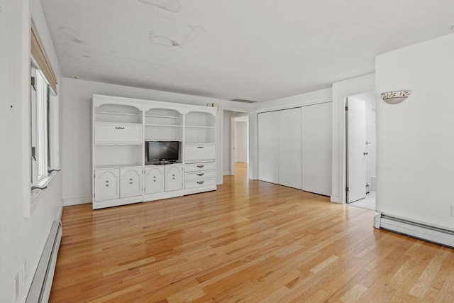 13 Community House Rd, Kennebunkport, ME 04046 - unfurnished living room featuring a baseboard radiator and light wood-style flooring