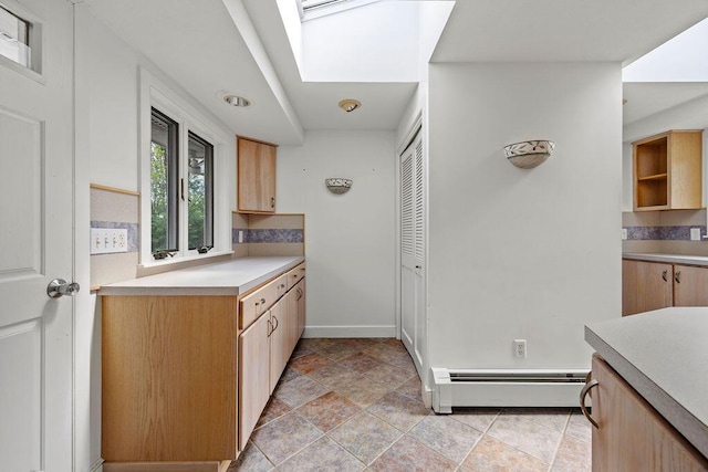 13 Community House Rd, Kennebunkport, ME 04046 - kitchen with baseboard heating, light countertops, decorative backsplash, and light stone finish floors