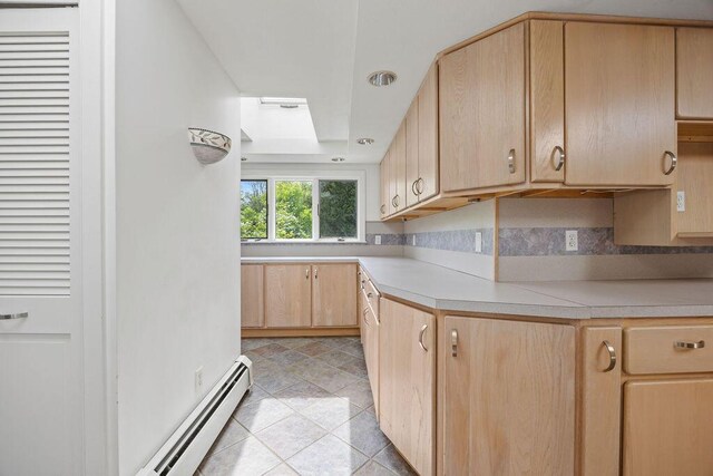 13 Community House Rd, Kennebunkport, ME 04046 - kitchen featuring light brown cabinets, light countertops, a baseboard heating unit, decorative backsplash, and a skylight