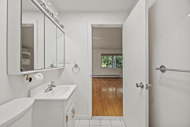13 Community House Rd, Kennebunkport, ME 04046 - half bath featuring baseboard heating, vanity, and tile patterned floors