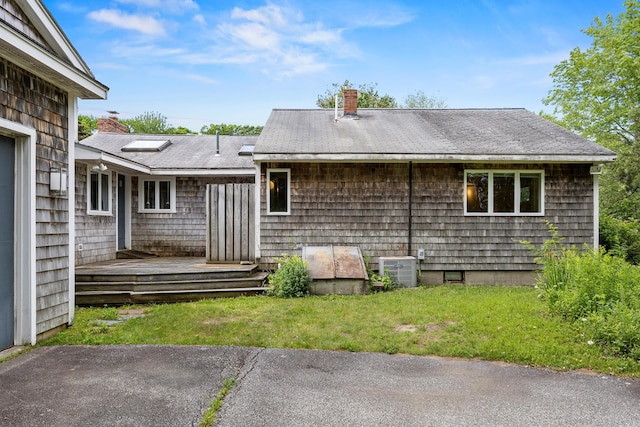 13 Community House Rd, Kennebunkport, ME 04046 - rear view of house with a chimney, a wooden deck, and a lawn