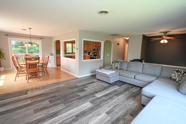 13 Evergreen Dr, Hampden, ME 04444 - living room with wood finished floors, arched walkways, a chandelier, and ceiling fan