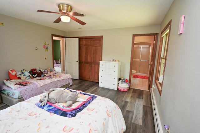 13 Evergreen Dr, Hampden, ME 04444 - bedroom featuring a baseboard radiator, dark wood-type flooring, a closet, ensuite bath, and ceiling fan