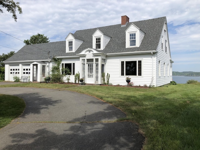 95 Main St, Lubec, ME 04652 - new england style home with a chimney, a shingled roof, a front yard, an attached garage, and driveway