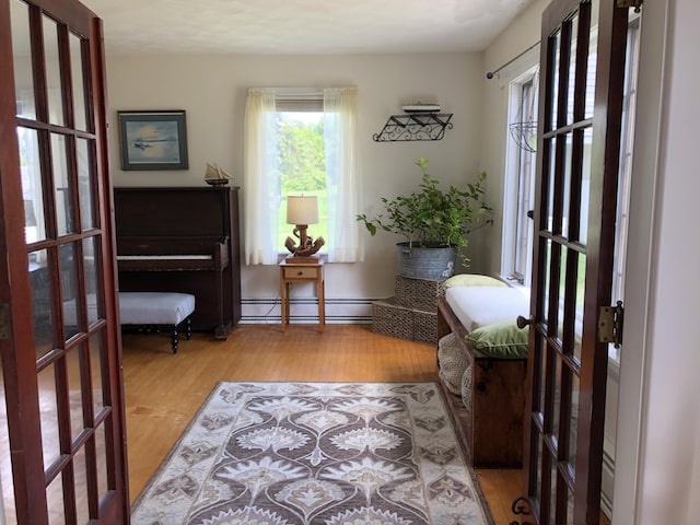 95 Main St, Lubec, ME 04652 - sitting room with a baseboard heating unit and wood finished floors