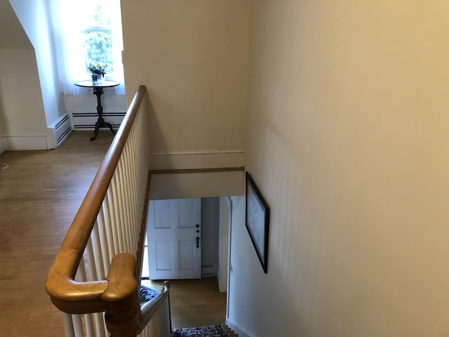 95 Main St, Lubec, ME 04652 - staircase with wood finished floors and a baseboard heating unit