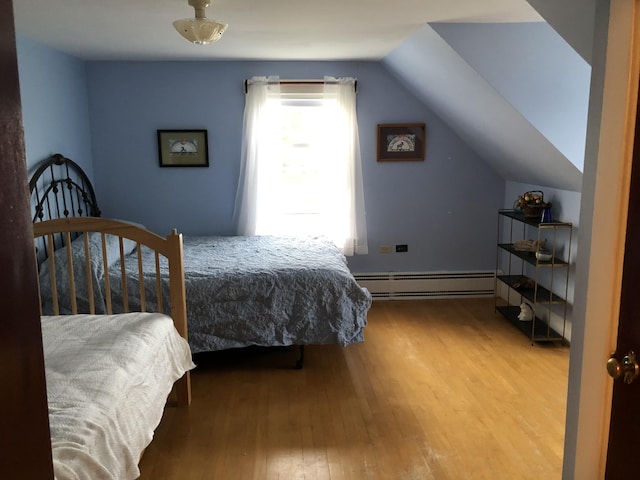 95 Main St, Lubec, ME 04652 - bedroom featuring a baseboard heating unit, wood finished floors, and lofted ceiling