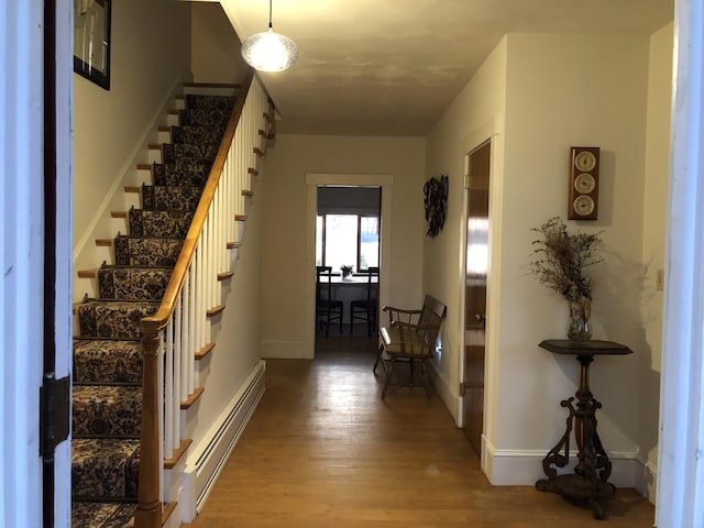 95 Main St, Lubec, ME 04652 - foyer entrance with baseboard heating, wood finished floors, and stairway