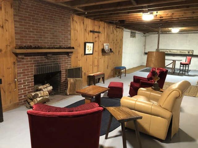 95 Main St, Lubec, ME 04652 - living area featuring finished concrete flooring, a brick fireplace, and wood walls
