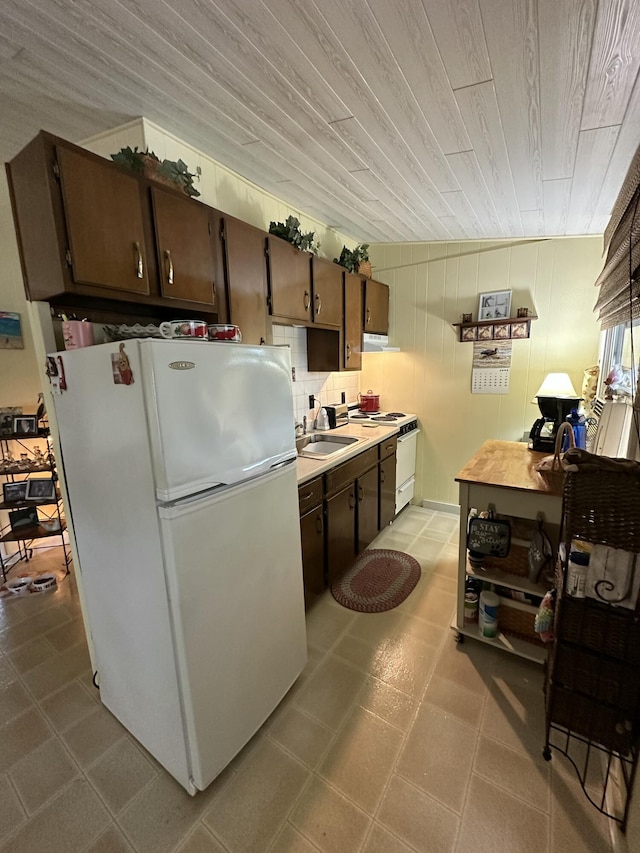85 Mile Rd Unit 13, Wells, ME 04090 - kitchen featuring white appliances, light countertops, dark brown cabinets, and wooden ceiling