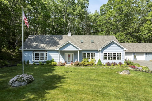 28 Evergreen Dr, Boothbay, ME 04537 - view of front of house with a front lawn, a chimney, and roof with shingles